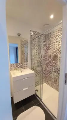a bathroom with a shower and a sink and a mirror at Charming apartment at heart of Brussels-Marolles in Brussels