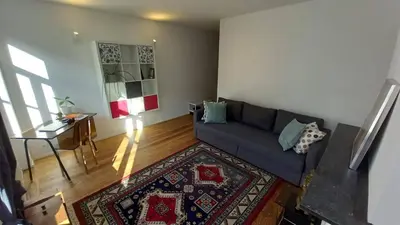 a living room with a couch and a table at Charming apartment at heart of Brussels-Marolles in Brussels