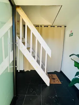 a staircase in a room with a tiled floor at Ruime studio met eigen ingang en private badkamer in Opwijk