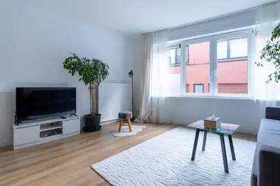 a living room with a tv and a couch at Apartment-Gravensteen in Ghent