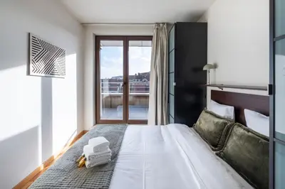 a bedroom with a large bed with a window at Brussels EU Center residence in Brussels