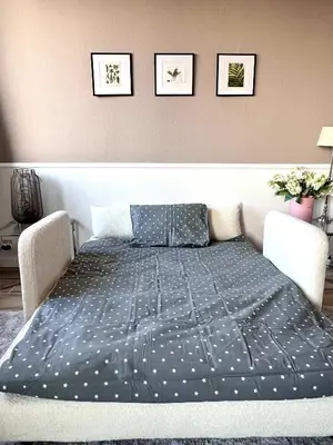 a bed with a blue comforter in a room at Lovely appartment - Heart of Brussels for 2 view over the city in Brussels