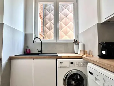 a kitchen with a washing machine and a sink at Lovely appartment - Heart of Brussels for 2 view over the city in Brussels