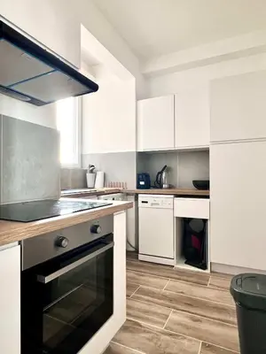 a kitchen with white cabinets and a stove top oven at Lovely appartment - Heart of Brussels for 2 view over the city in Brussels