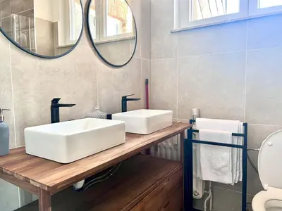 a bathroom with a white sink and a mirror at Lovely appartment - Heart of Brussels for 2 view over the city in Brussels