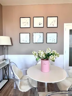 a white table with a vase of flowers on a wall at Lovely appartment - Heart of Brussels for 2 view over the city in Brussels