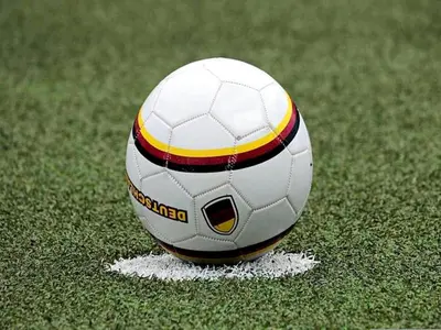 a soccer ball is sitting on the grass at 6-Guest Escape with Private Garden & Wi-Fi in Ravels