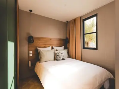 a bedroom with a large white bed with a window at 6-Guest Escape with Private Garden & Wi-Fi in Ravels