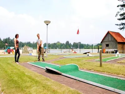 two people standing next to a skateboard ramp in a park at Two-Bedroom Retreat in the Heart of Kempen in Ravels