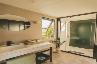 a bathroom with a tub and a sink and a mirror at Two-Bedroom Retreat in the Heart of Kempen in Ravels