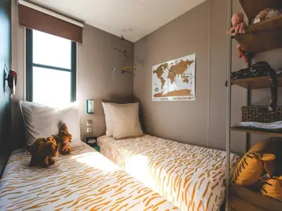 a bedroom with two beds and two teddy bears at Two-Bedroom Retreat in the Heart of Kempen in Ravels