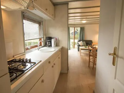 a kitchen with a sink and a stove top oven at Stay with Beach and Minigolf Views in Ravels