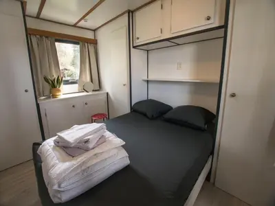 a bedroom with a bed in a small room at Stay with Beach and Minigolf Views in Ravels