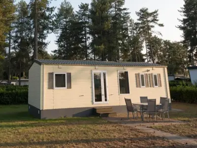 a tiny house with a table and chairs at 3-Bedroom Central Retreat in Ravels in Ravels
