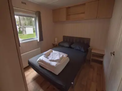 a small bedroom with a bed and a window at 3-Bedroom Central Retreat in Ravels in Ravels