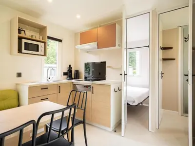 a kitchen and dining room with a table and chairs at Cordelia Lodge with Garden & Picnic Area in Ravels