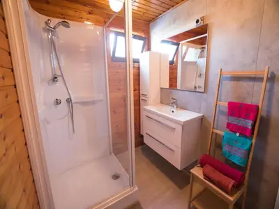 a bathroom with a shower and a sink at Luxury Forest Lodge with Private Garden in Ravels