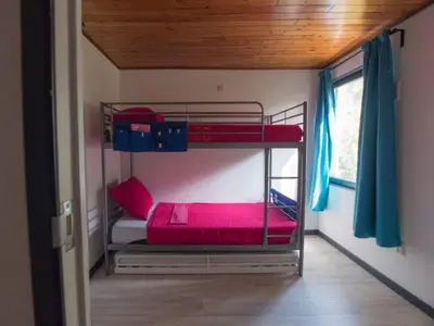a bunk bed room with two bunk beds in it at Luxury Forest Lodge with Private Garden in Ravels