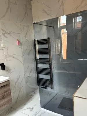 a bathroom with a shower with a glass door at Suzanne house in Brussels