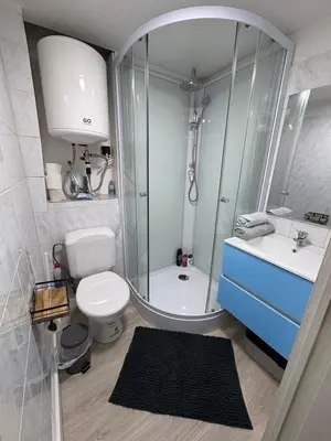 a bathroom with a shower and a toilet and a sink at Duplex near Brussels Airport with washing machine in Vilvoorde