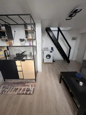 a room with a kitchen and a living room at Duplex near Brussels Airport with washing machine in Vilvoorde