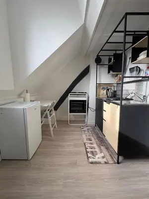 a kitchen with a stove and a refrigerator at Duplex near Brussels Airport with washing machine in Vilvoorde