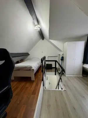 a room with two bunk beds and a mirror at Duplex near Brussels Airport with washing machine in Vilvoorde