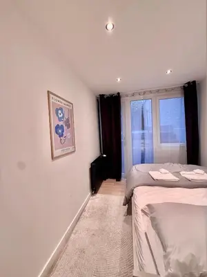 a bedroom with two beds and a window at European Quarter Studio in Brussels