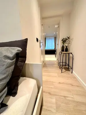 a living room with a couch and a wooden floor at European Quarter Studio in Brussels