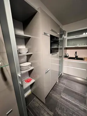 a kitchen with white cabinets and a sink at Maison Melis Antwerp in Antwerp