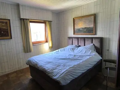 a bedroom with a bed and a window at Willa Sunny Garden in Sint-Laureins