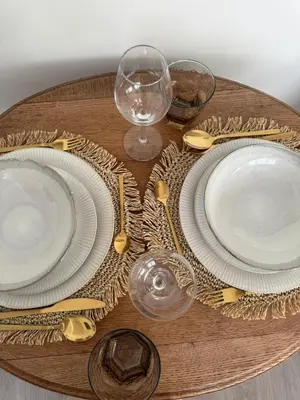 a table with plates and wine glasses on a table at Calm & Stylish Apartment Atomium Area Bruxelles in Wemmel