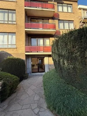 a brick building with a walkway in front of it at Calm & Stylish Apartment Atomium Area Bruxelles in Wemmel