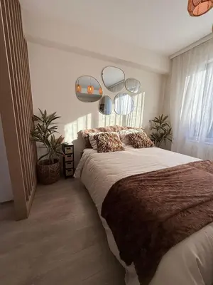 a bedroom with a large bed and two mirrors at Calm & Stylish Apartment Atomium Area Bruxelles in Wemmel
