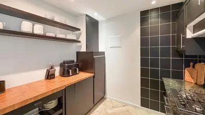 a kitchen with black and white tiles on the wall at Modern apartment near City Centre, Luna CasaMia in Mellet