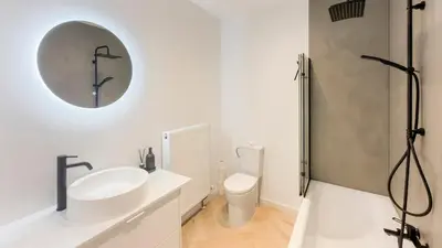 a white bathroom with a sink and a toilet at Modern apartment near City Centre, Luna CasaMia in Mellet