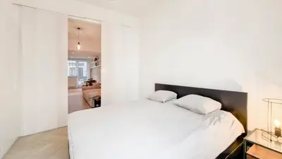 a bedroom with a large white bed with two pillows at Modern apartment near City Centre, Luna CasaMia in Mellet