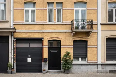 a building with two garage doors and a balcony at Modern apartment near City Centre, Luna CasaMia in Mellet