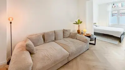 a living room with a couch and a bed at Modern apartment near City Centre, Luna CasaMia in Mellet