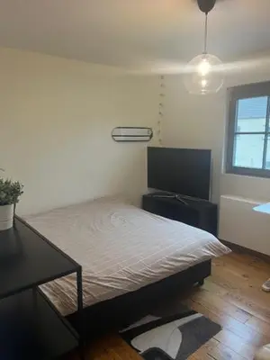 a bedroom with a bed and a flat screen tv at Guesthouse Dolores with Breakfast perfect for Tomorrowland Festival in Waasmunster