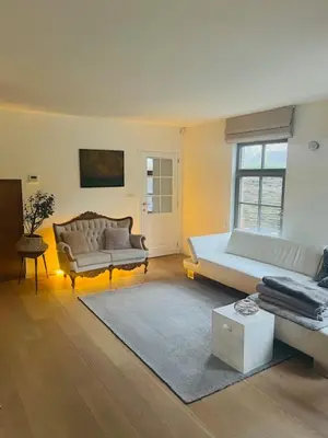 a living room with a couch and a table and a couch at Guesthouse Dolores with Breakfast perfect for Tomorrowland Festival in Waasmunster