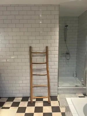 a bathroom with a towel rack and a shower at Guesthouse Dolores with Breakfast perfect for Tomorrowland Festival in Waasmunster