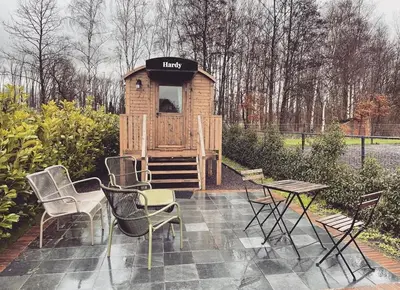 a wooden play house with chairs and a table at Laurel & Hardy in Mechelen