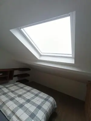 a window in a room with a bed in front of it at Excelente localização in Brussels