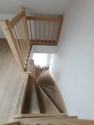 a spiral staircase in a room with a white wall at Excelente localização in Brussels