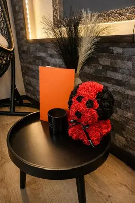 a table with a bouquet of red roses on it at Tomorrowland Luxury Apartment in Boom