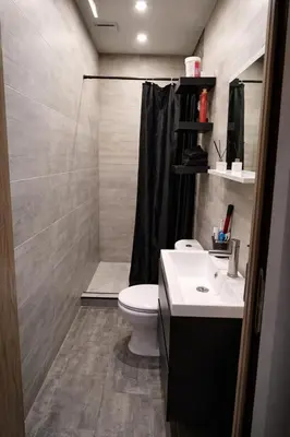 a bathroom with a toilet and a sink and a shower at Tomorrowland Luxury Apartment in Boom