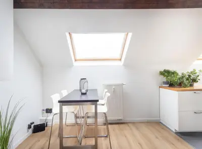 a table and chairs in a kitchen with a window at Escapade cosy Quartier EU Place Jourdan in Brussels
