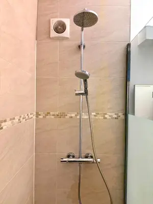 a shower with a shower head in a bathroom at 3 min to the Grand-Place 6 min to Manneken Pis & Sleeps 6 in Brussels