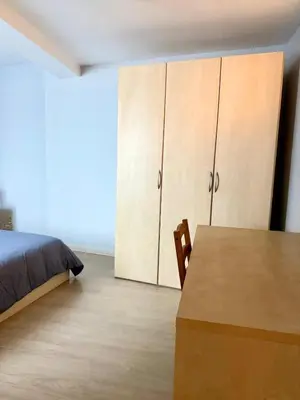 a bedroom with a bed and a desk and cabinets at 3 min to the Grand-Place 6 min to Manneken Pis & Sleeps 6 in Brussels